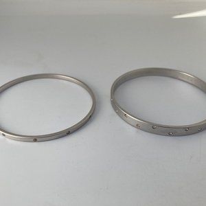 Swarovski silver tone metal bangles (two)